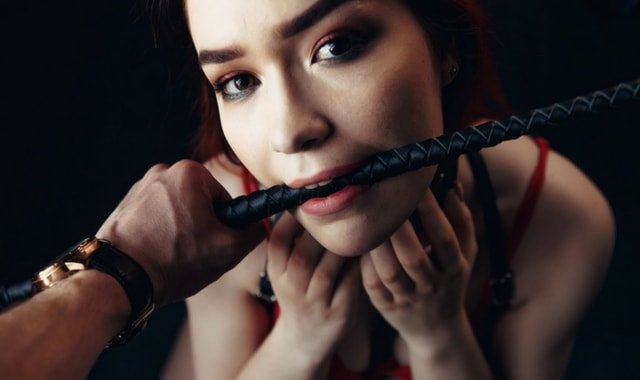 BDSM explained: Woman with collar and crop