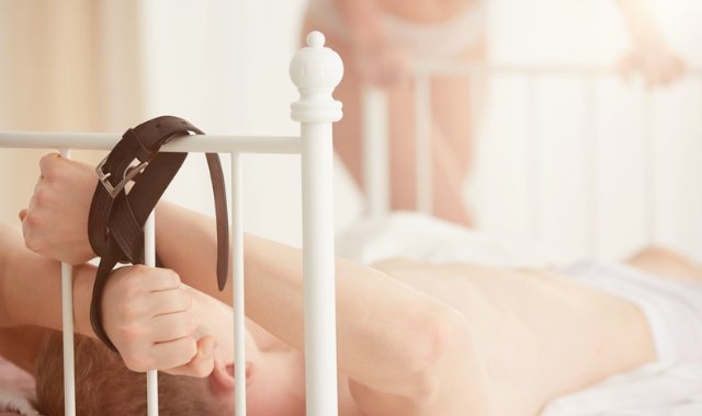 man tied to bed in orgasm denial fantasy