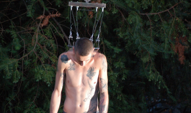 body suspension - image of man being suspended