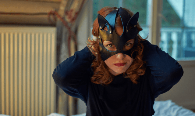 Woman coming out kinky taking off her mask