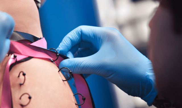 Play piercing needles, skin being laced