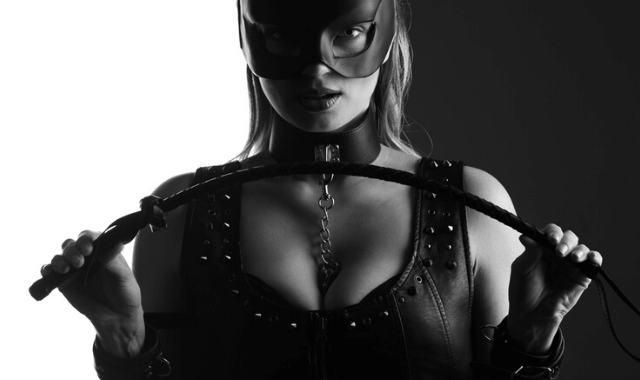 BDSM legal: masked woman holding a crop