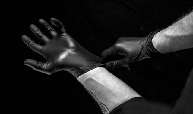 Safe sex practices: man putting on latex gloves